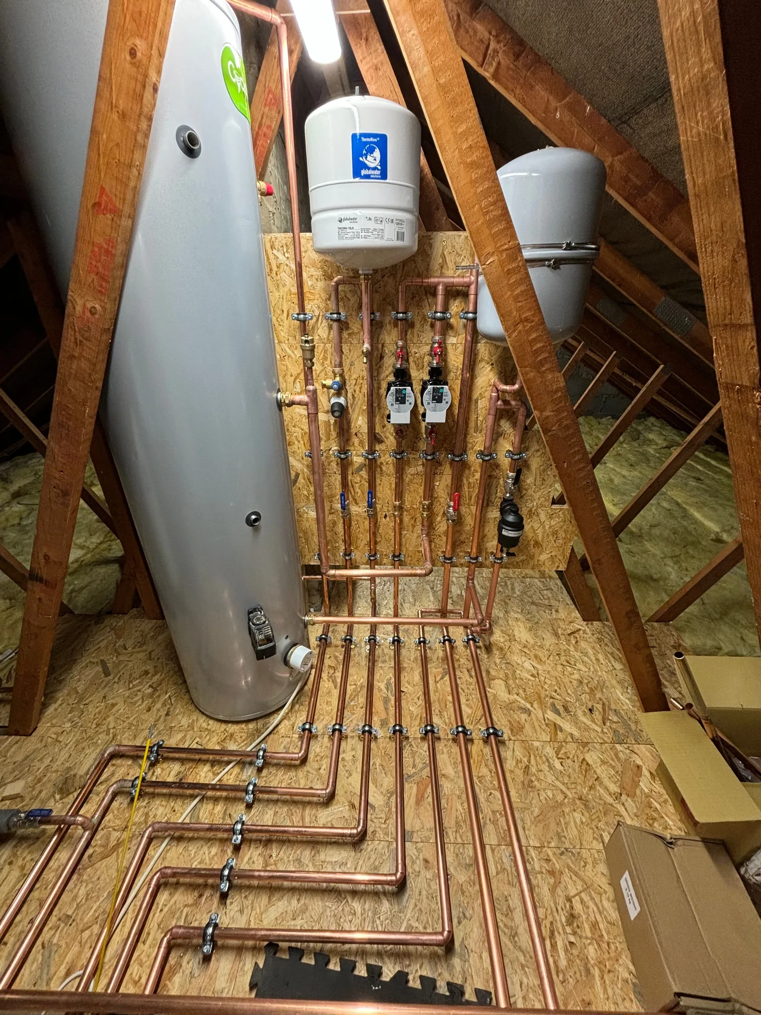 Loft cylinder, expansion vessels and manifold pipework by Howe Heating